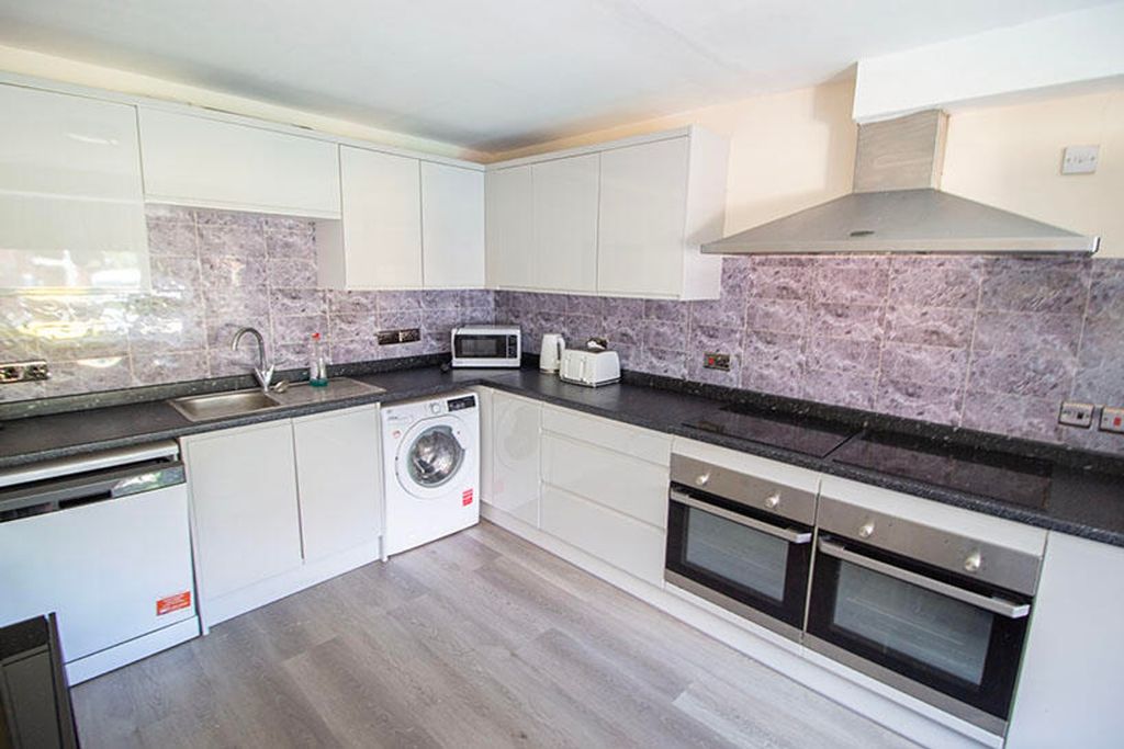 Property photo 2 of 4 Modern Kitchen Featuring Sleek Cabinetry And Ample...