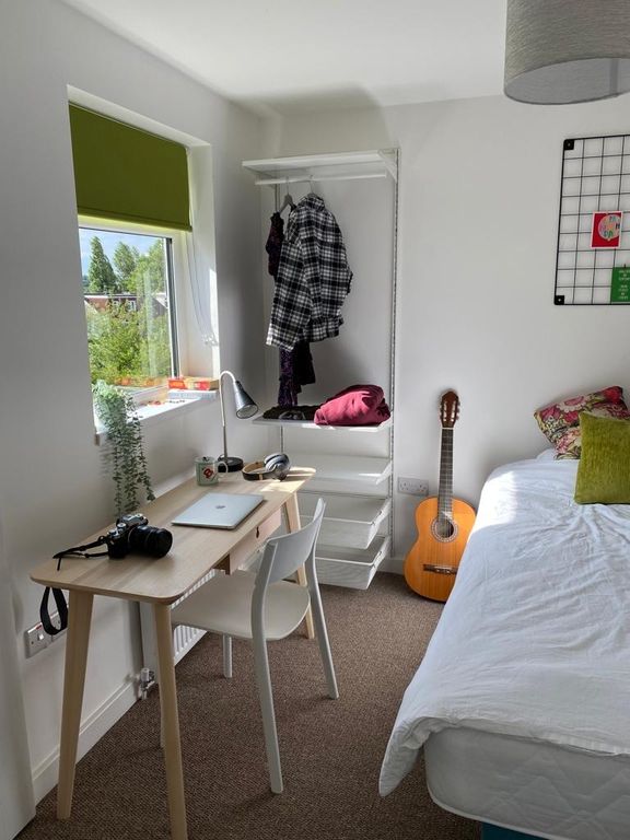 Property photo 2 of 15 A Cozy And Well-Lit Bedroom Featuring A Tidy Desk ...