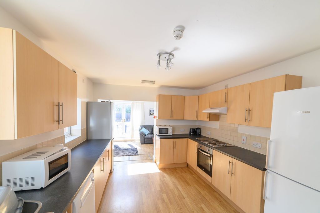 Property photo 3 of 12 Bright And Modern Kitchen With Ample Wood-Finished...