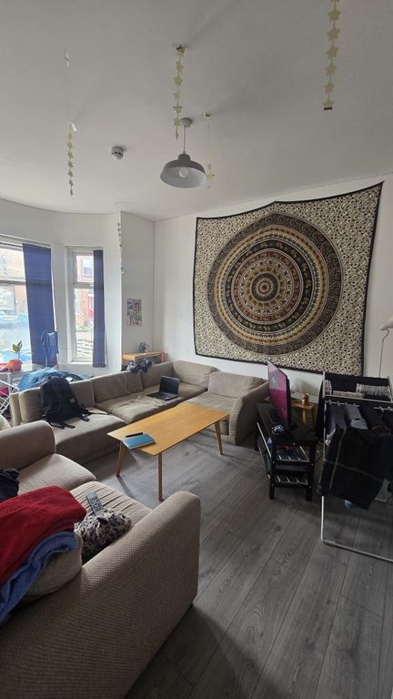 Property photo 2 of 18 A Cozy Living Room Featuring A Spacious L-Shaped S...