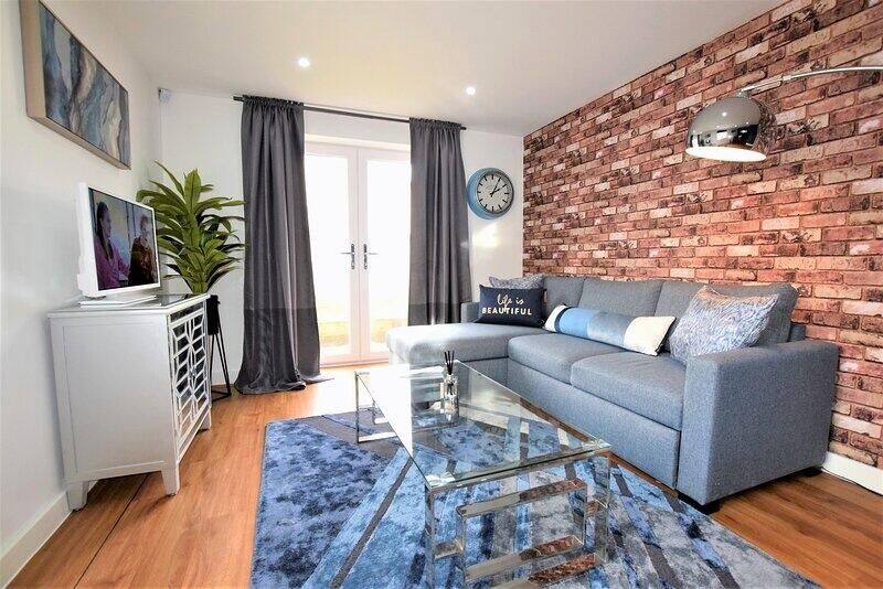 Property photo 2 of 7 A Modern Living Room Featuring A Stylish Exposed B...