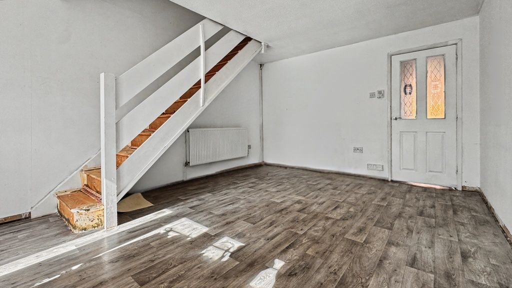 Property photo 3 of 9 Bright Living Area With Modern Wood-Style Floor...