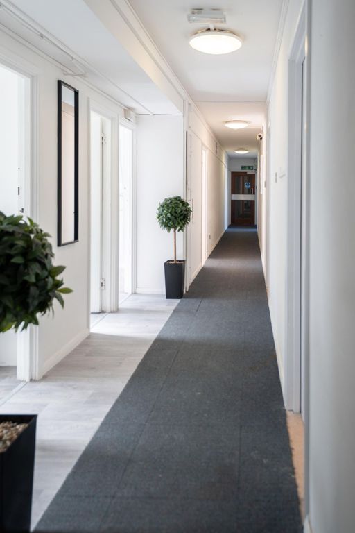 Property photo 1 of 13 A Clean, Well-Lit Hallway Featuring White Walls, m...