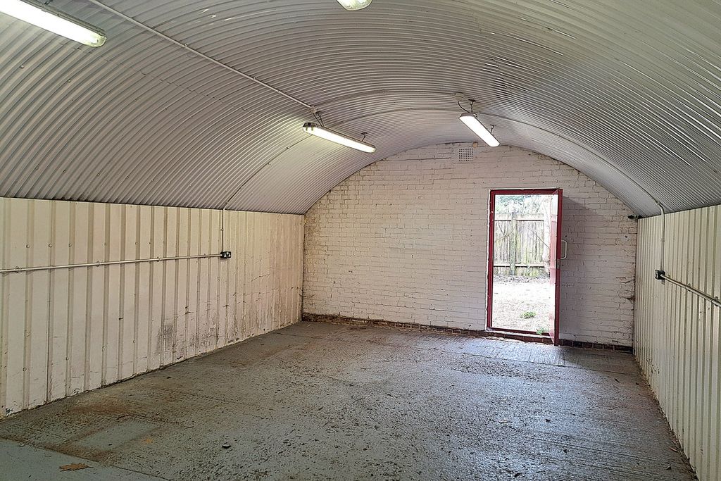 Property photo 2 of 5 An Empty Arch With White Lining And A Fire Escape Door At The Back.