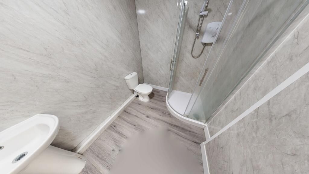 Property photo 1 of 12 Compact Bathroom Featuring A Modern Corner Shower ...