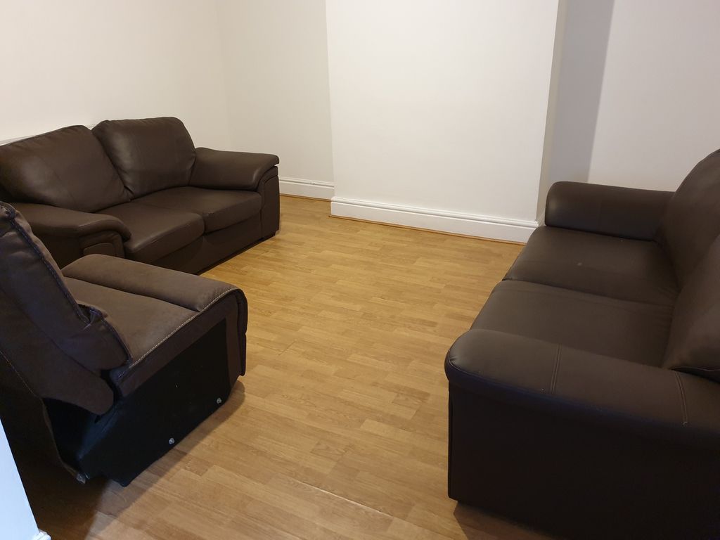 Property photo 2 of 15 A Cozy Living Room Featuring Comfortable Brown Lea...