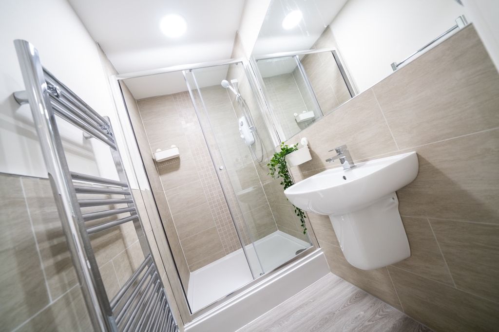Property photo 3 of 8 Bright And Modern Bathroom Featuring A Spacious Sh...