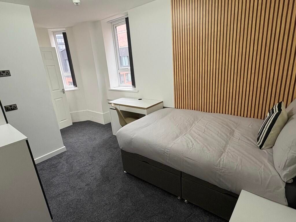 Property photo 2 of 12 A Modern And Spacious Bedroom Featuring A Comforta...