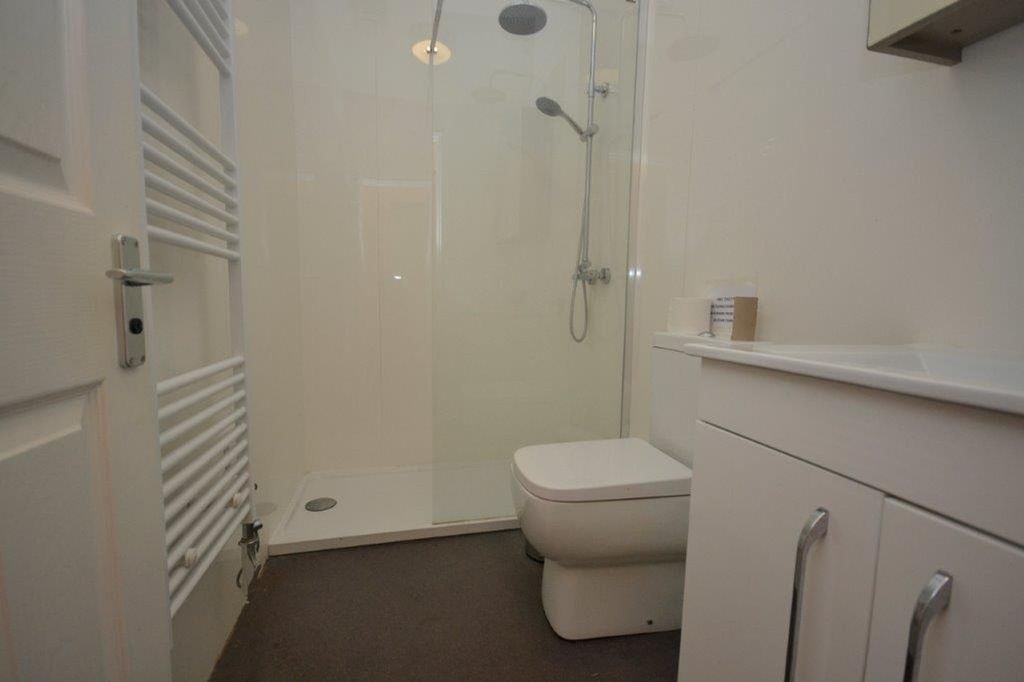 Property photo 3 of 12 A Clean And Modern Bathroom Featuring A Shower And...