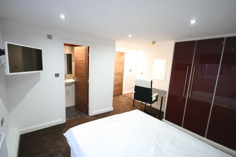 Property photo 3 of 6 A Bright And Modern Bedroom Featuring A Large Ward...