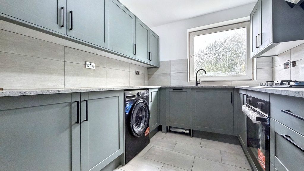 Property photo 3 of 5 Modern Galley Kitchen With Muted Green Cabinetry, ...