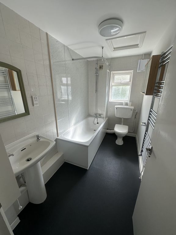 Property photo 2 of 5 Bright And Clean Bathroom Featuring A Bathtub With...