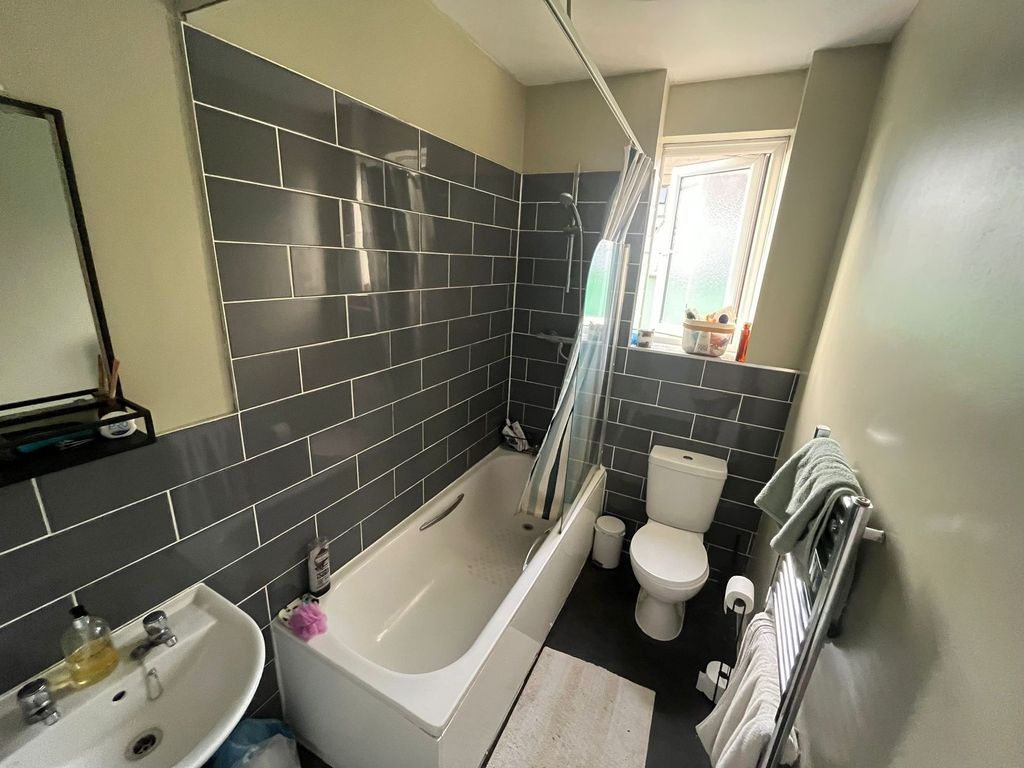 Property photo 3 of 7 Well-Maintained Bathroom Featuring A White Bathtub...