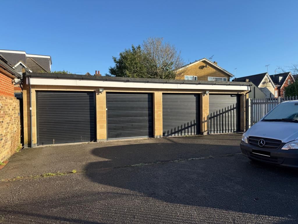 Property photo 1 of 8 Four Garages With Black Roller Shutter Fronts