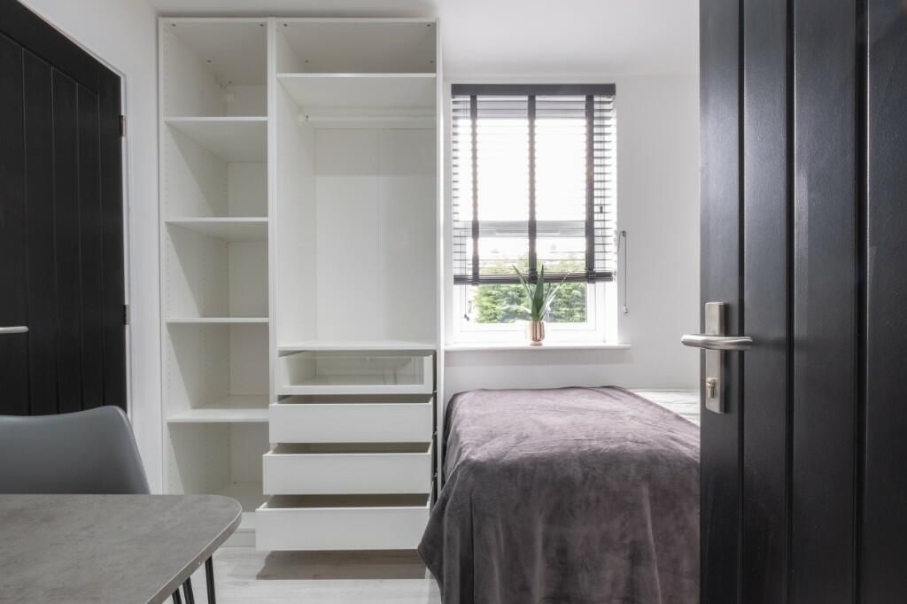 Property photo 3 of 11 A Well-Lit Bedroom Featuring A Bed With Neatly Mad...