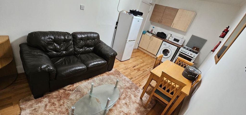 Property photo 1 of 9 A Cozy Living Area Featuring A Black Leather Sofa,...