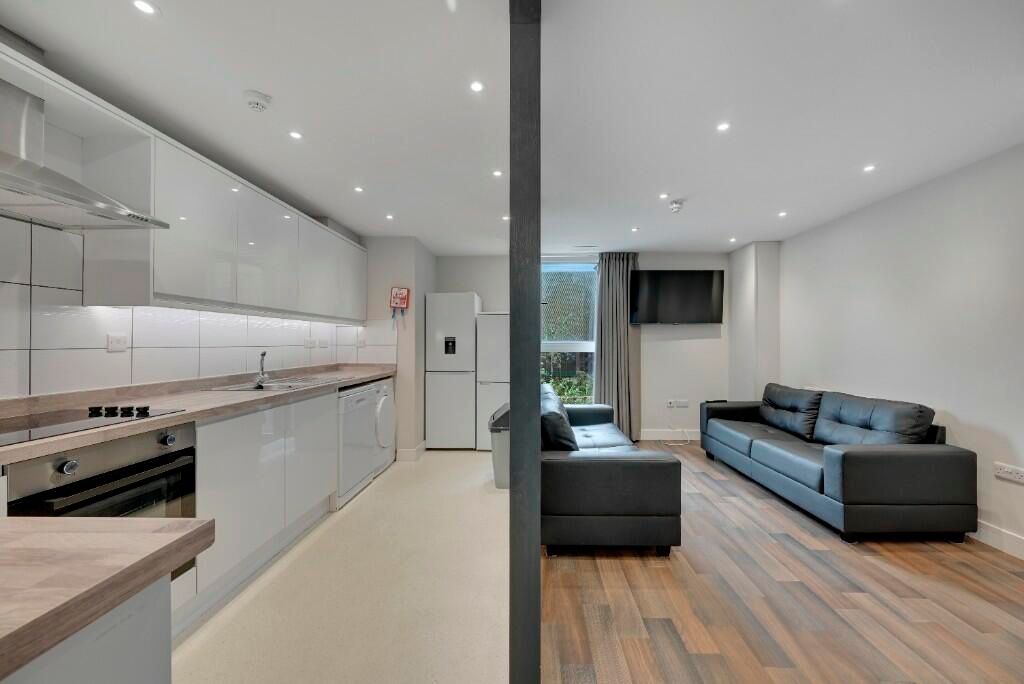 Property photo 1 of 16 A Modern, Bright Living Room Featuring Sleek Black...