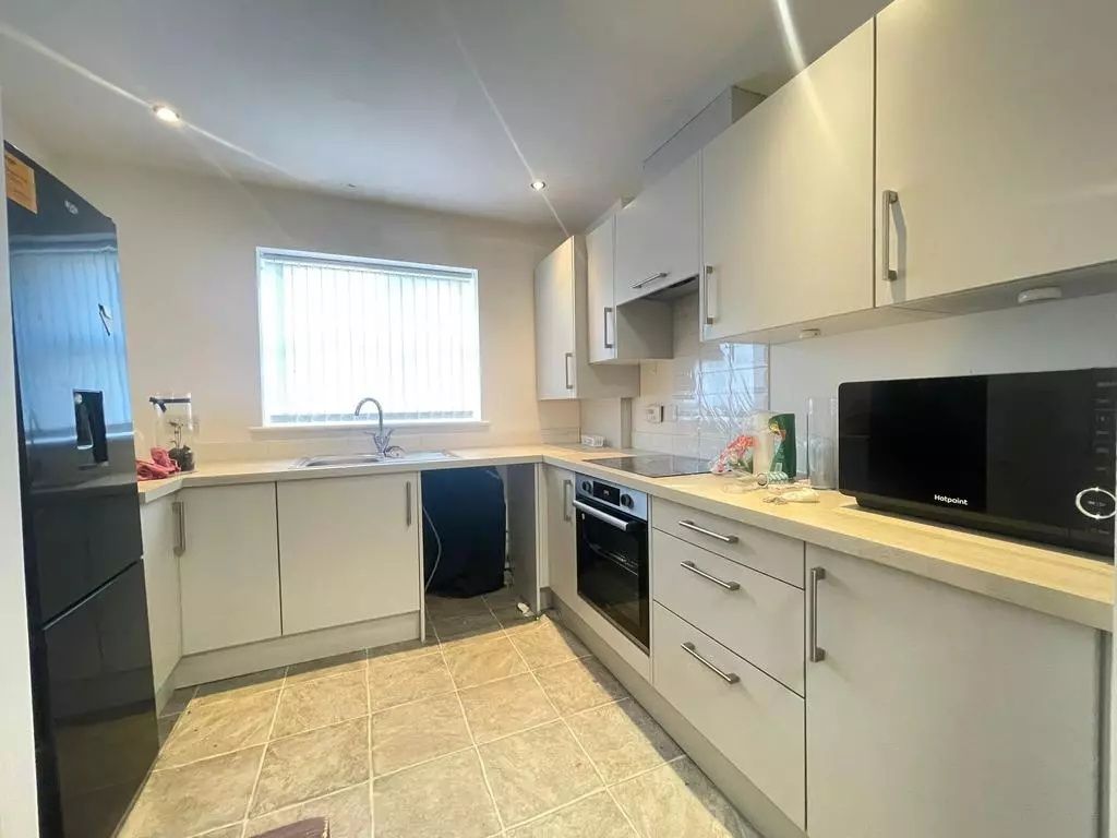 Property photo 1 of 4 This Modern Kitchen Boasts Ample Counter Space And...