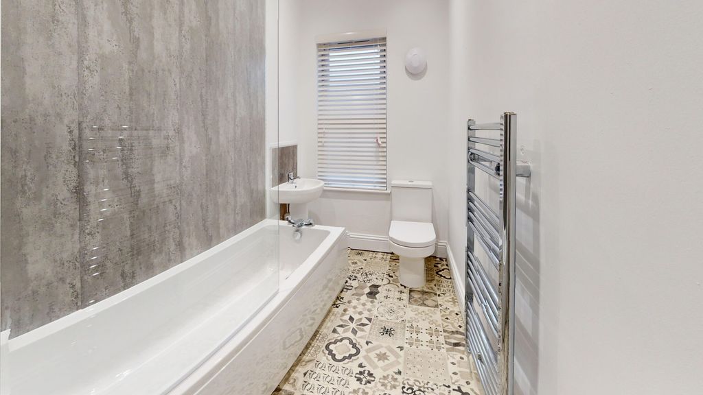 Property photo 2 of 15 A Modern And Stylish Bathroom Featuring A Bath And...