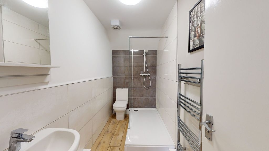 Property photo 1 of 14 A Modern And Clean Bathroom Featuring Sleek Tiles ...