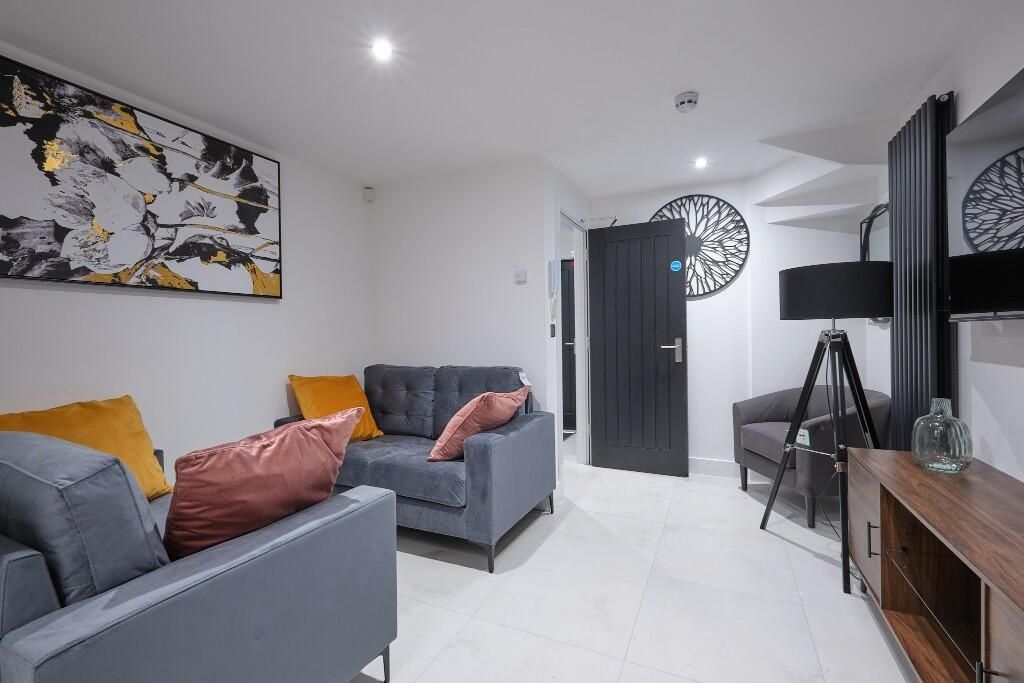 Property photo 3 of 12 Bright And Modern Living Room Featuring Stylish Gr...