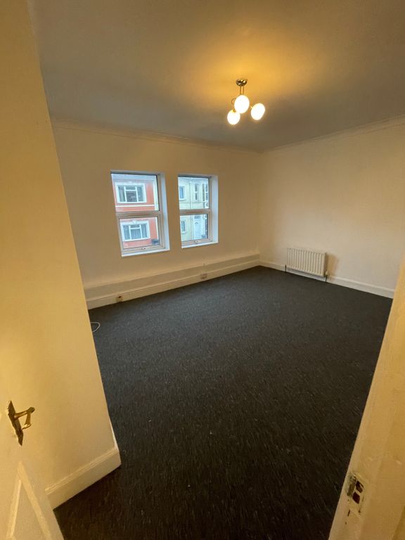 Property photo 2 of 10 A Spacious Living Room Featuring Large Windows Tha...