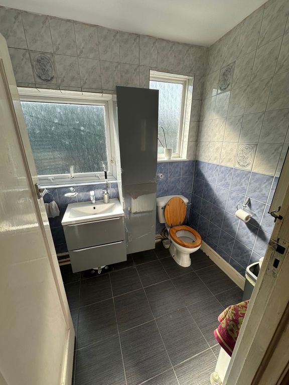 Property photo 3 of 9 A Bright Bathroom Featuring Modern Grey And Blue W...