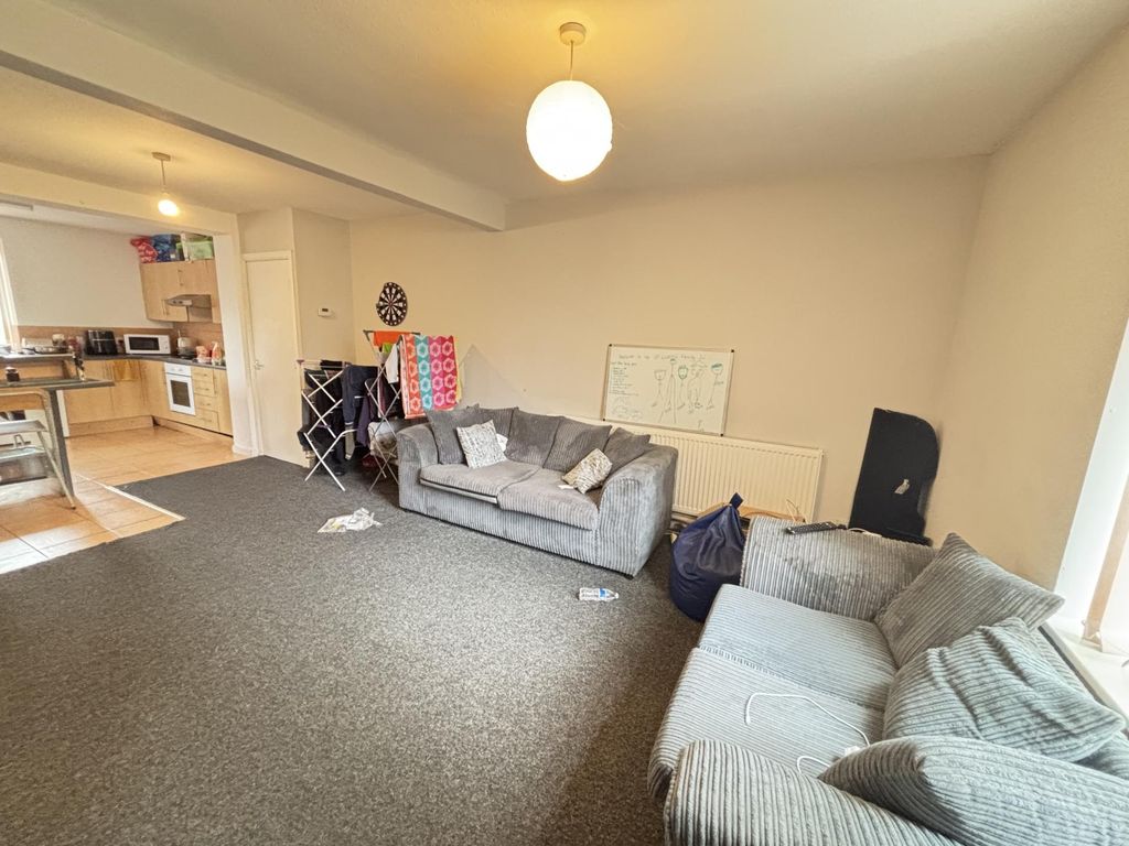 Property photo 3 of 8 A Spacious, Well-Lit Living Room Featuring Comfort...