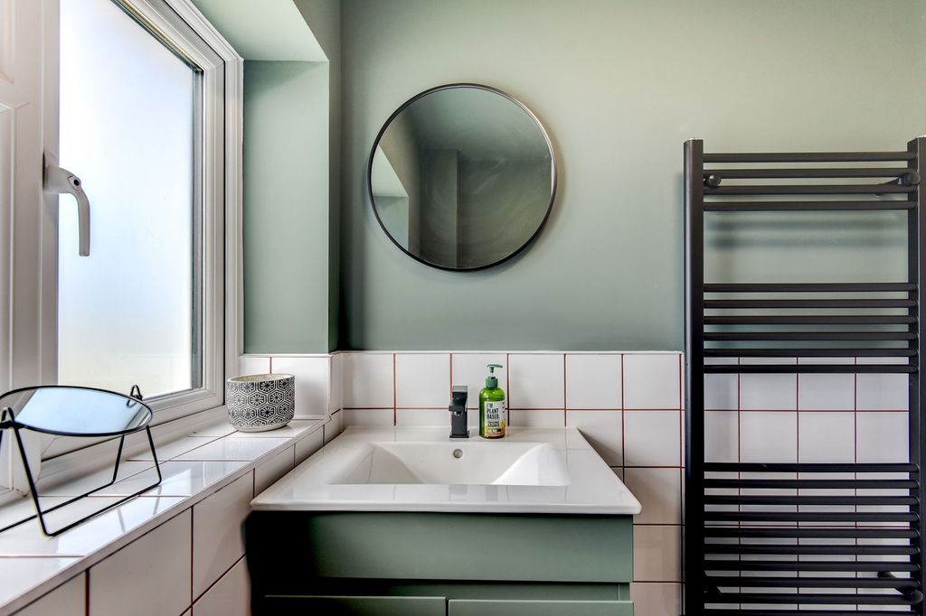 Property photo 2 of 6 A Stylish Bathroom Featuring A Modern Sink With A ...