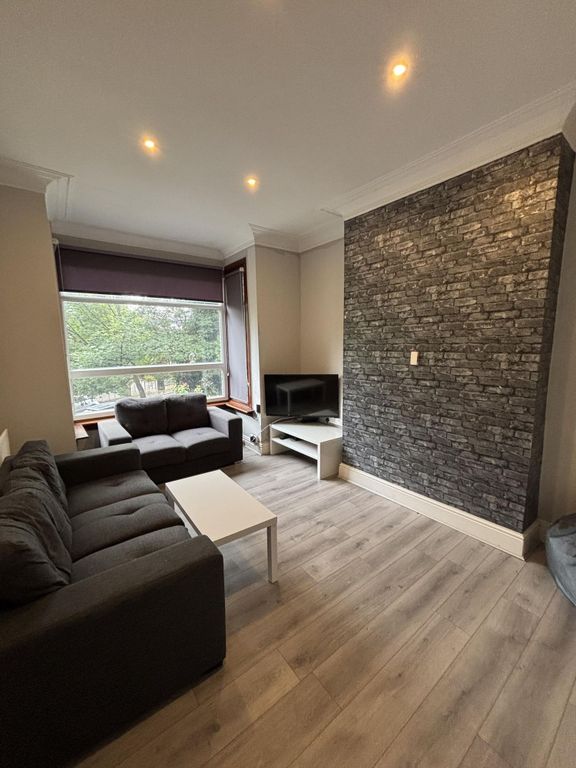 Property photo 1 of 18 A Modern And Inviting Living Room Featuring Comfor...