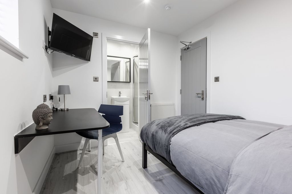 Property photo 3 of 7 A Modern, Well-Lit Bedroom Featuring A Comfortable...