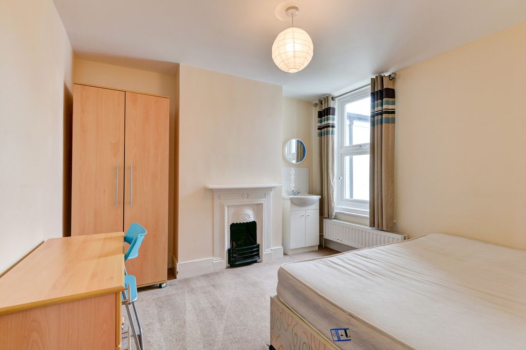 Property photo 2 of 16 A Spacious And Well-Lit Bedroom With A Comfortable...