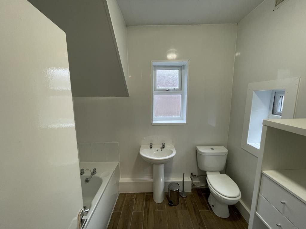 Property photo 1 of 6 Bright And Modern Bathroom Featuring A Stylish Bat...