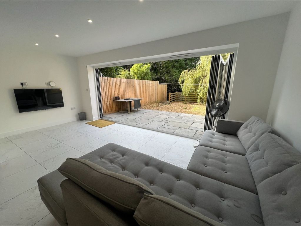 Property photo 1 of 12 Bright And Spacious Living Room Featuring Large Bi...