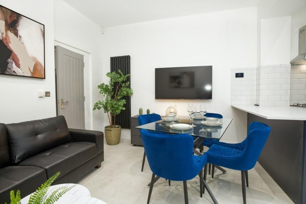 Property photo 3 of 12 Spacious And Modern Living Room Featuring A Sleek ...