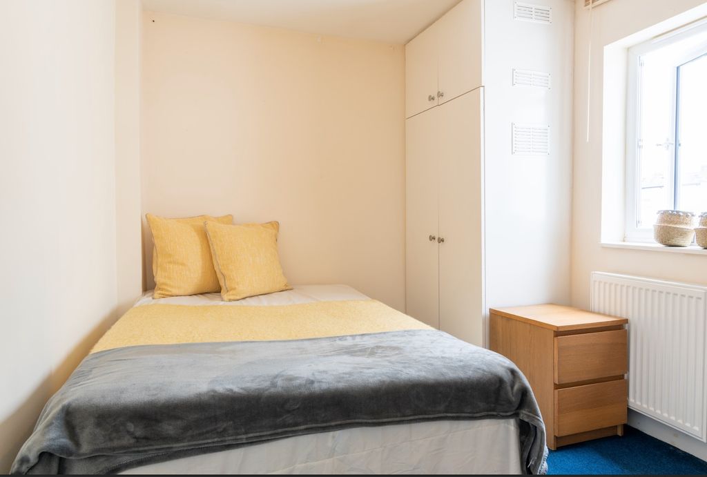 Property photo 3 of 11 Cozy Double Bedroom Featuring Warm Tones And Ample...