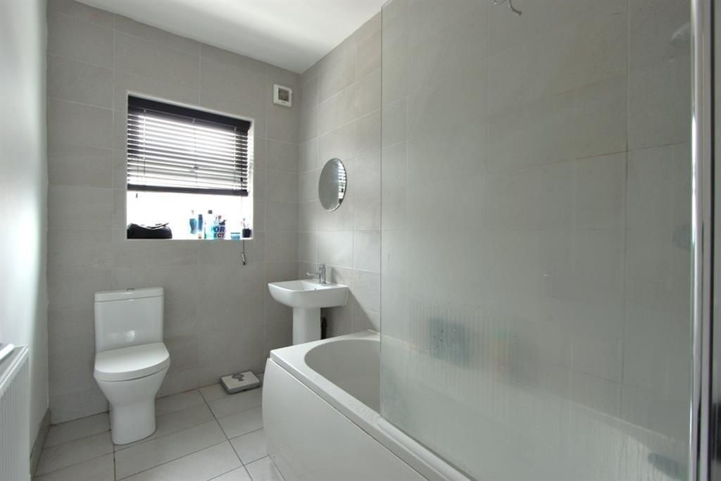 Property photo 3 of 15 A Bright, Modern Bathroom Featuring A Clean White ...