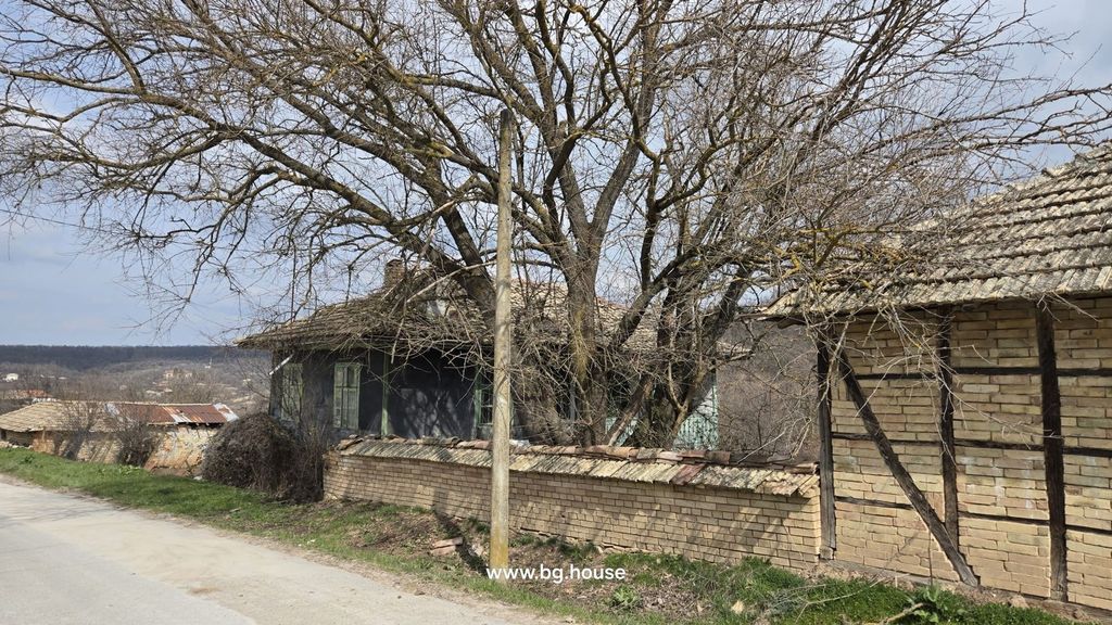 Property photo 3 of 49 Rural House Partially Visible Behind A Brick Wall With Leafless Trees And A Distant View Of The Village Landscape.