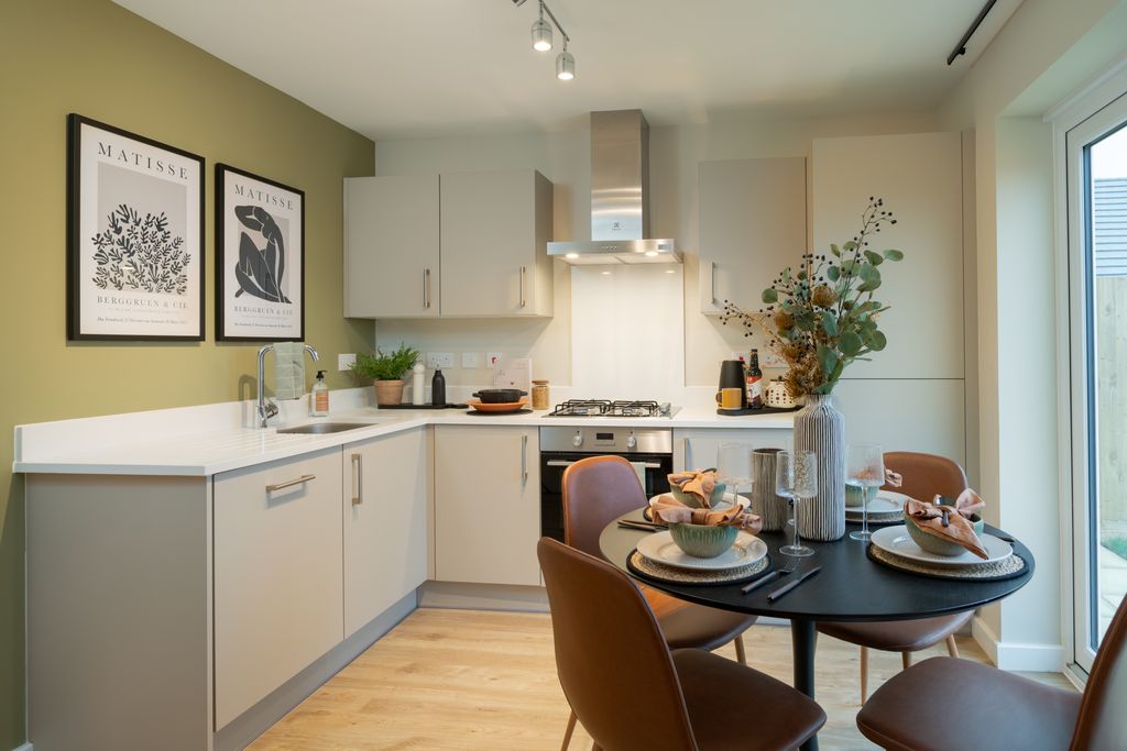 Property photo 3 of 8 A Modern Kitchen With A Dining Table Set For A Meal In The Foreground And A Sleek