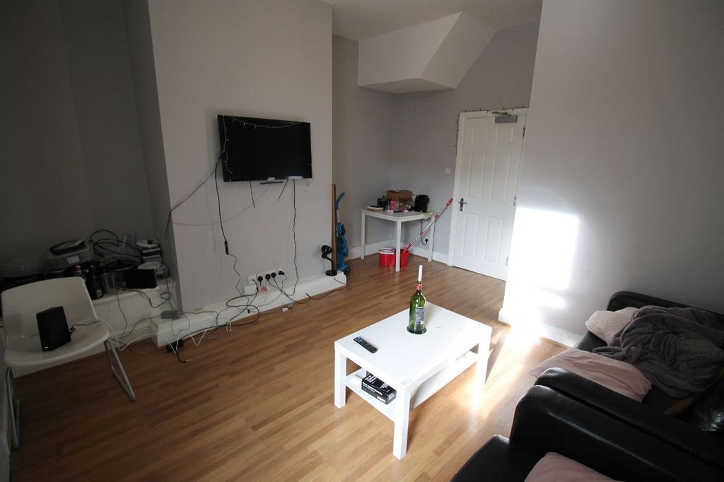 Property photo 3 of 8 This Contemporary Living Room Features A Well-Lit ...