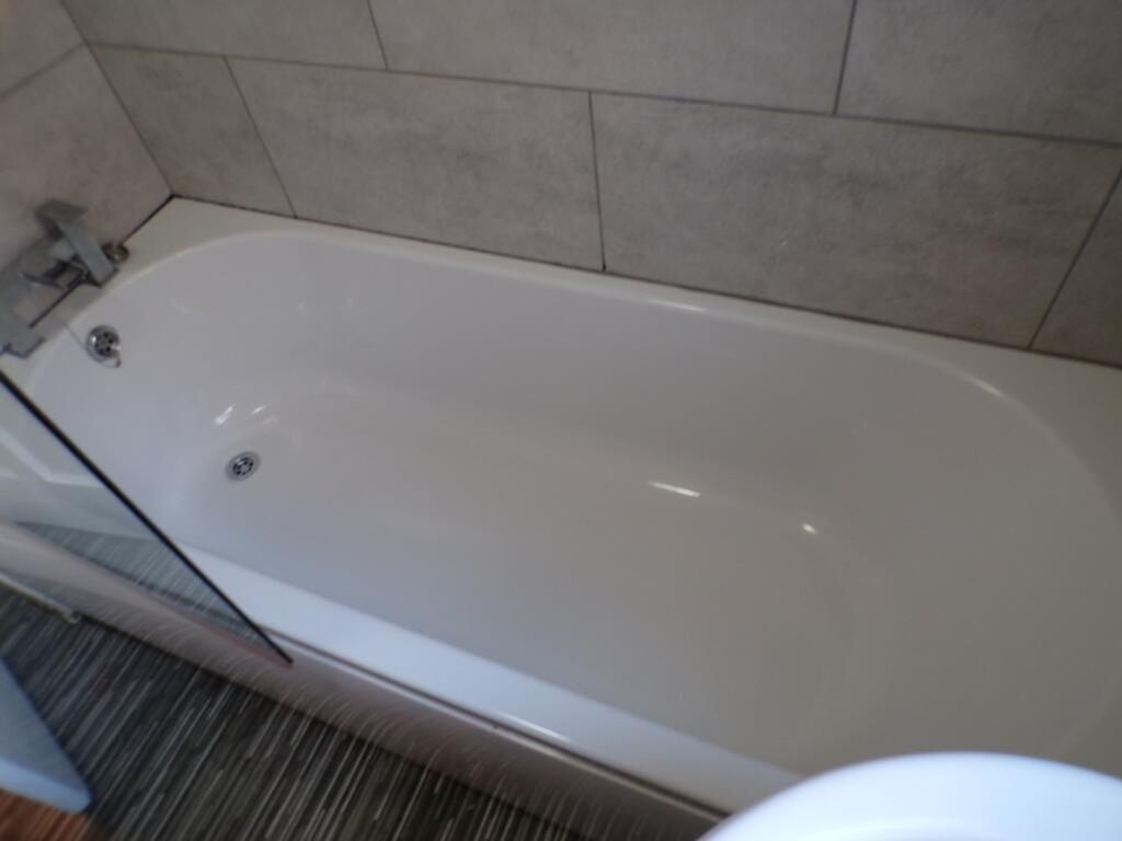 Property photo 2 of 9 This Well-Maintained Bathroom Features A Sleek Bat...