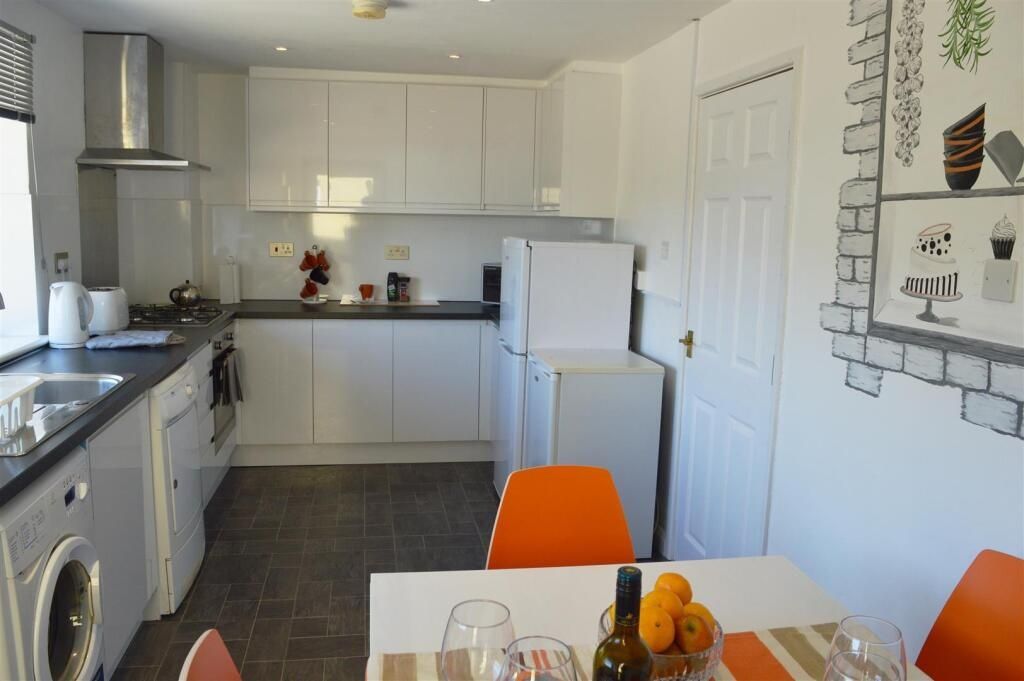 Property photo 2 of 10 This Bright And Modern Kitchen Features Sleek Cabi...
