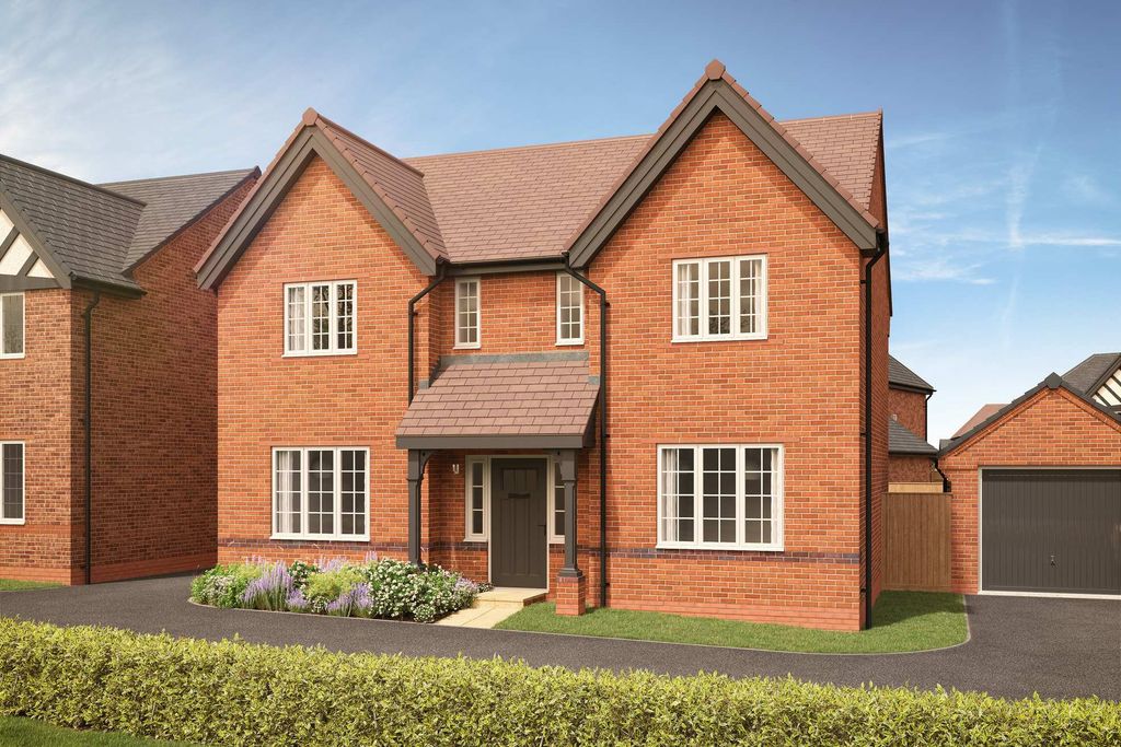 Property photo 1 of 11 A Red Brick House With White-Trimmed Windows And A Dark Garage Door Sits Behind A Manicured Hedge Un