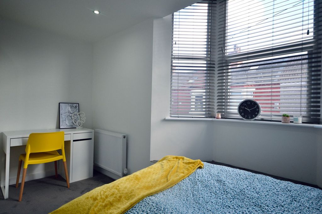Property photo 3 of 4 A Bright, Modern Bedroom Featuring A Large Window ...