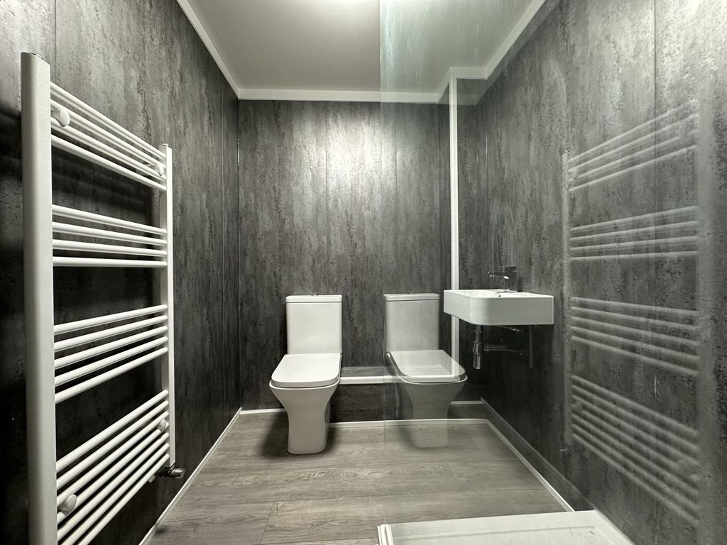 Property photo 2 of 7 A Modern And Clean Bathroom Featuring A Toilet, A ...