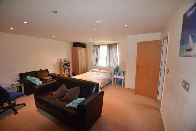 Property photo 1 of 11 A Spacious And Welcoming Living Room Featuring Com...