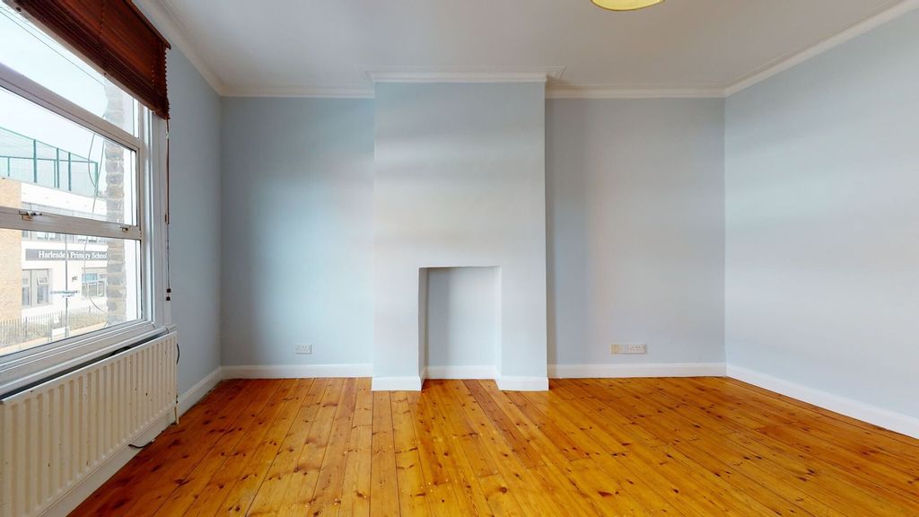 Property photo 3 of 18 Bright And Spacious Bedroom Featuring Polished Woo...