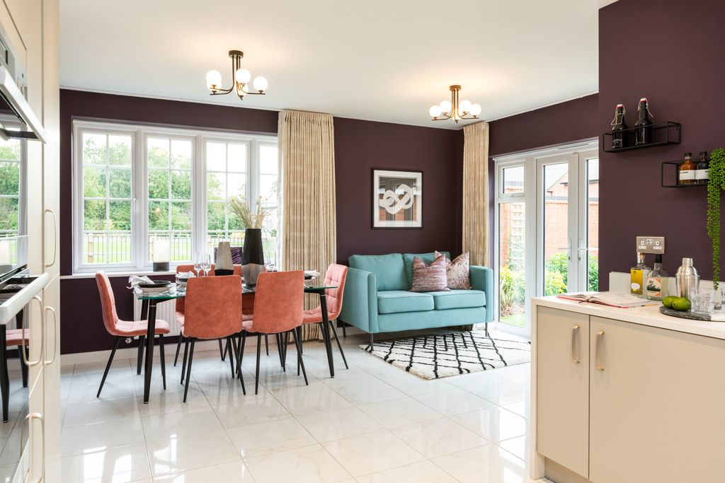Property photo 3 of 10 A Dining Set With Coral Chairs And A Teal Sofa Are In The Foreground