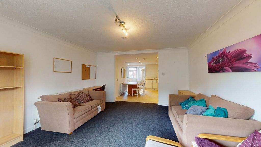 Property photo 2 of 15 A Spacious And Inviting Living Room With Modern De...