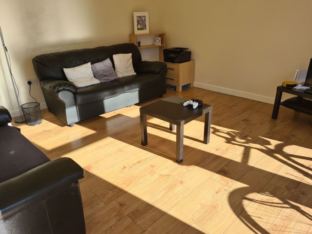 Property photo 3 of 24 A Bright And Inviting Living Room Featuring Comfor...